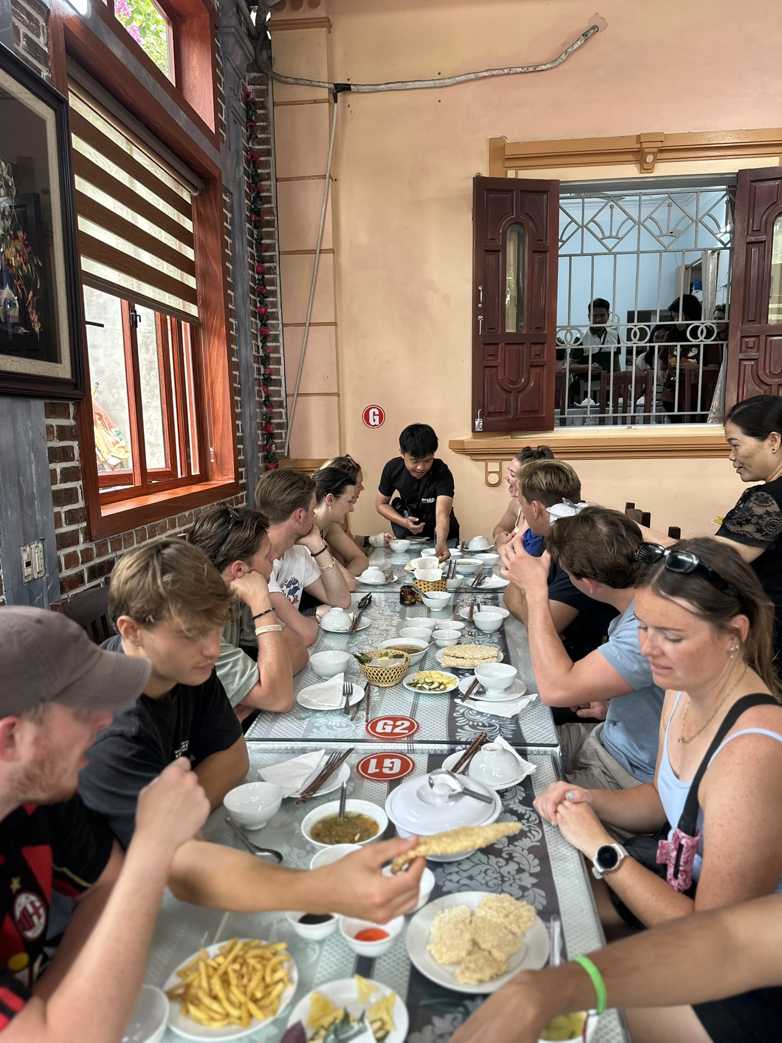 Starting the climb up the stone steps of Mua Cave